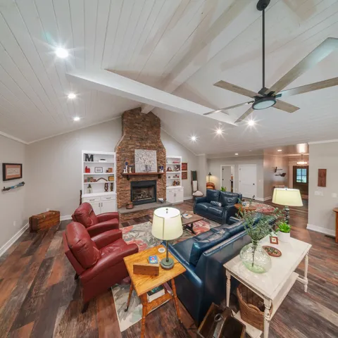 a living room with furniture and kitchen view