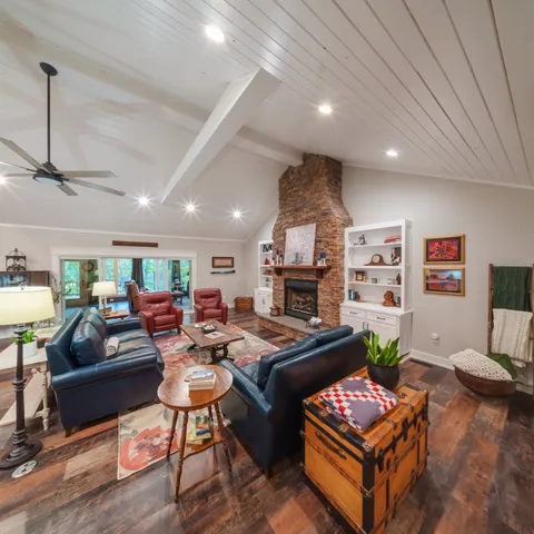 a kitchen with stainless steel appliances kitchen island granite countertop a table chairs sink and cabinets