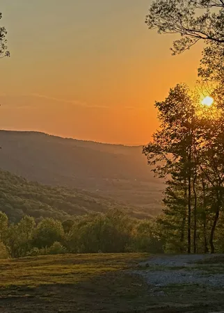 an aerial view of a house with a yard and lake view