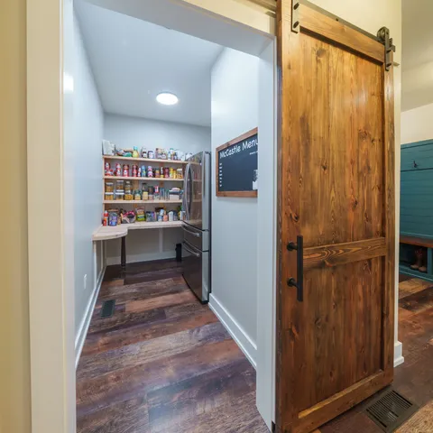 a kitchen with stainless steel appliances granite countertop wooden cabinets a dining table and chairs