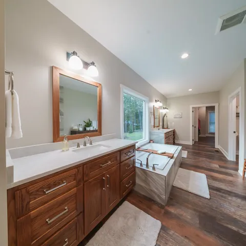 a living room with furniture a wooden floor and a sink