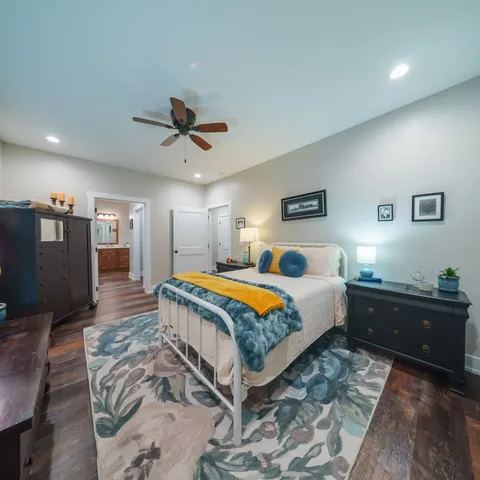 a view of an empty room with furniture and a window
