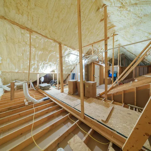 a view of a house with a small yard and wooden fence