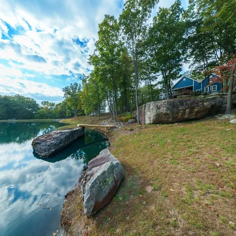 a view of a backyard with table and chairs and a fire pit