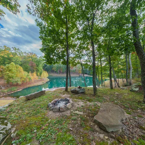 a backyard of a house with lots of green space table and chairs