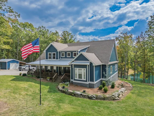 a view of a house with backyard and porch