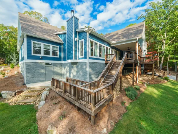 a house with green field in front of it