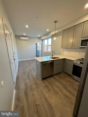 a kitchen with stainless steel appliances granite countertop a sink and a stove