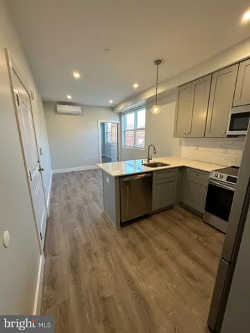 a kitchen with stainless steel appliances granite countertop a sink and a stove