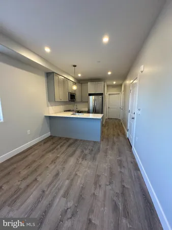a view of kitchen and wooden floor