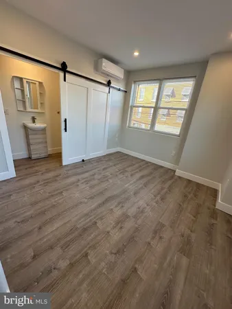 an empty room with windows and closet