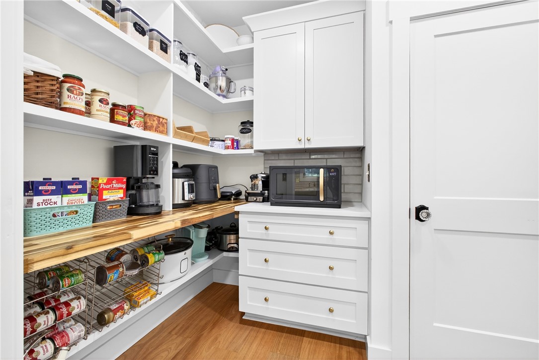 5016 Copeland Road Belton, SC 29627 - Photo 11 of 45 Functional pantry storage features a built-in countertop with appliances and plentiful shelving.