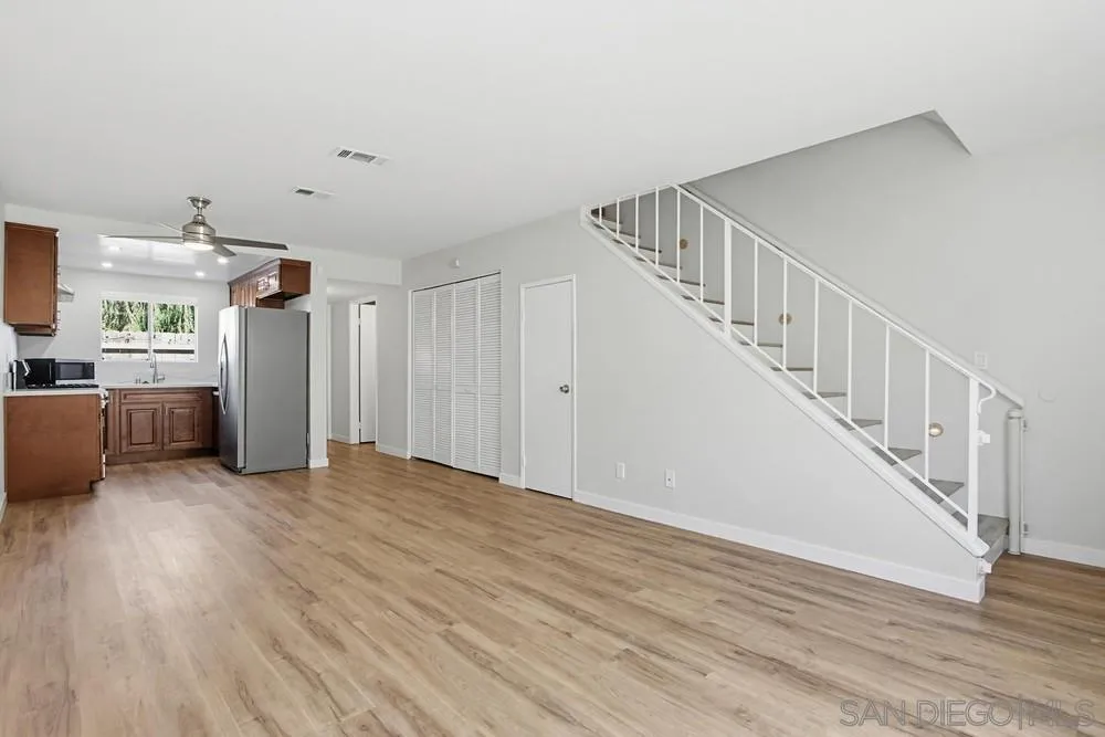 5130 North River Road, Unit B Oceanside, CA 92057 - Photo 16 of 51 a view of a livingroom with wooden floor and stairs
