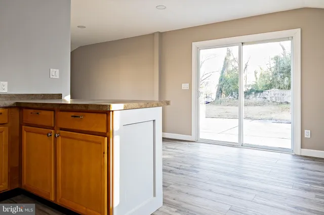 a view of a kitchen with wooden floor and cabinet