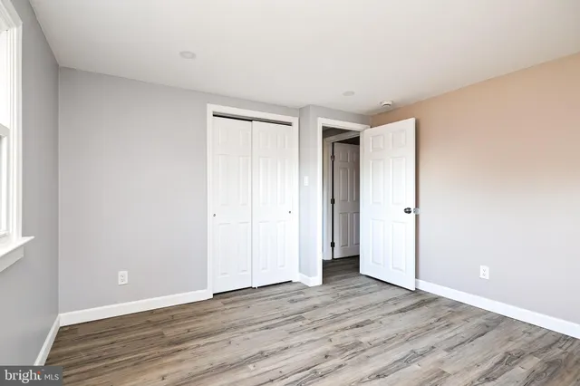 a view of an empty room and wooden floor