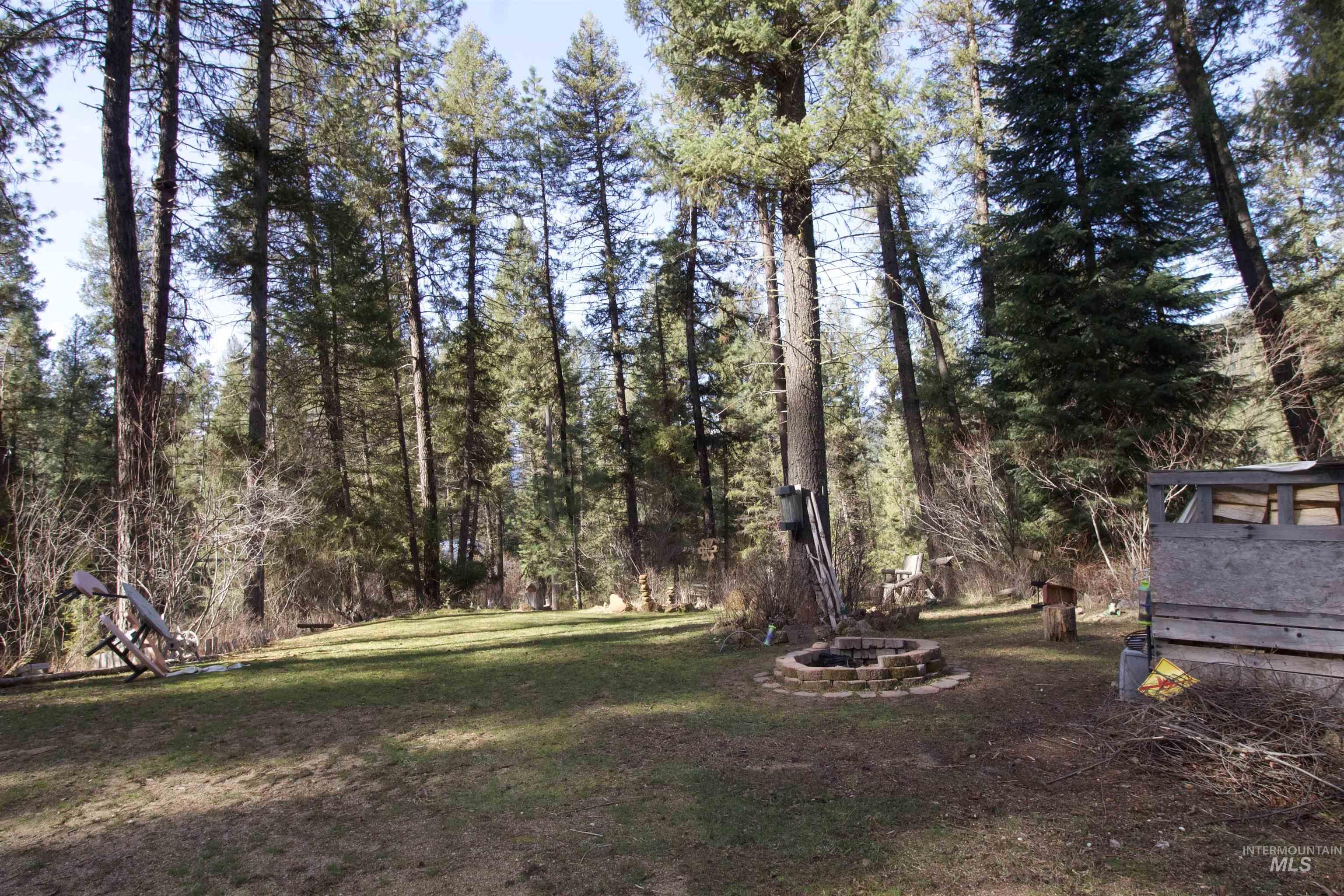 36 Lightning Creek Road Garden Valley, ID 83622 - Photo 4 of 12 View of green lawn featuring an outdoor fire pit