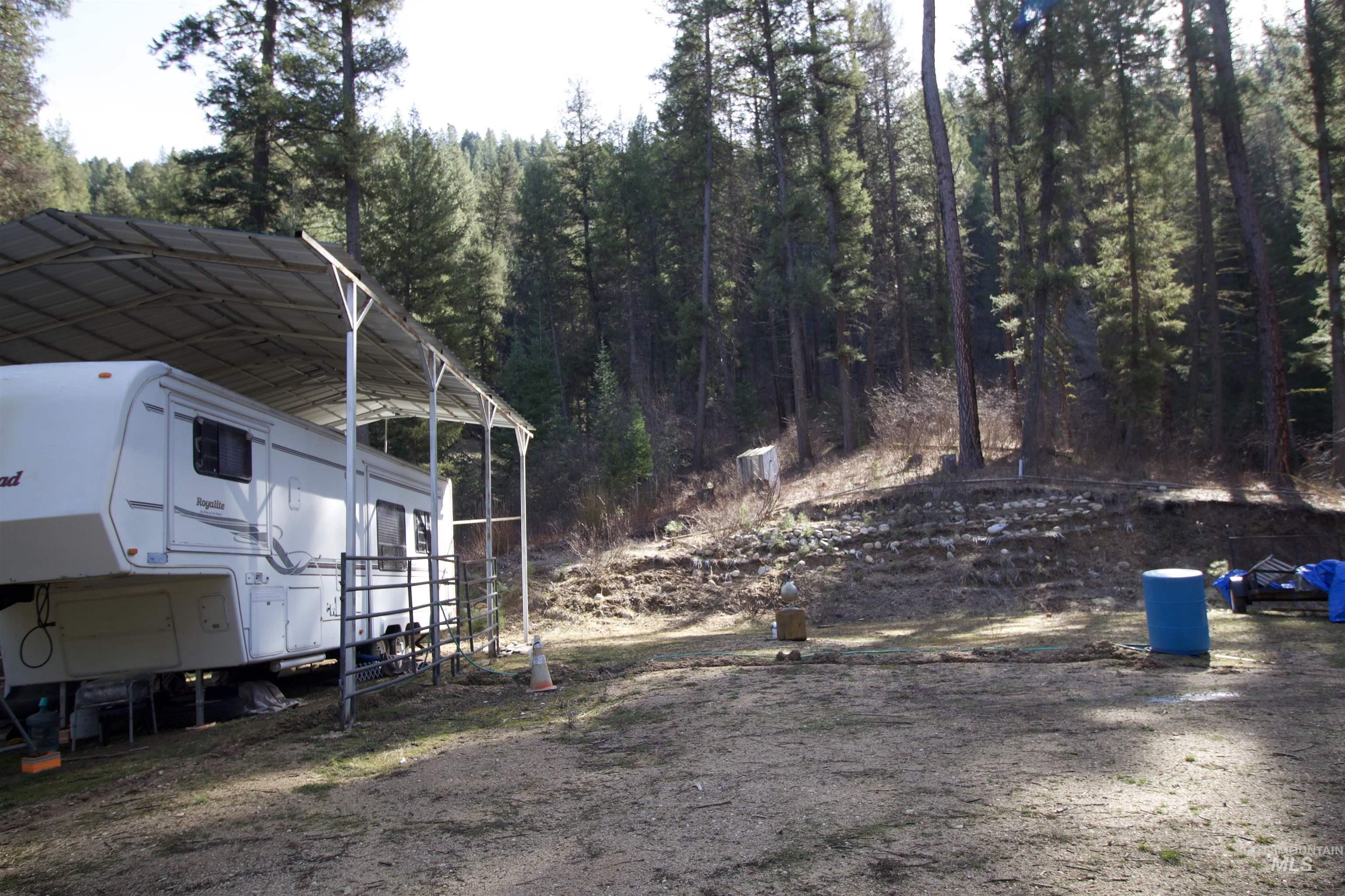 36 Lightning Creek Road Garden Valley, ID 83622 - Photo 9 of 12 View of yard featuring a detached carport and a forest view