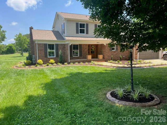 a front view of a house with a yard table and chairs