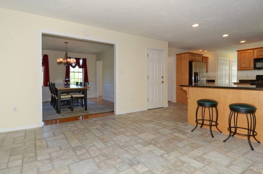 33 Quabbin Path Sutton, MA 01590 - Photo 8 of 27 a view of a kitchen with a dining table chairs and entryway