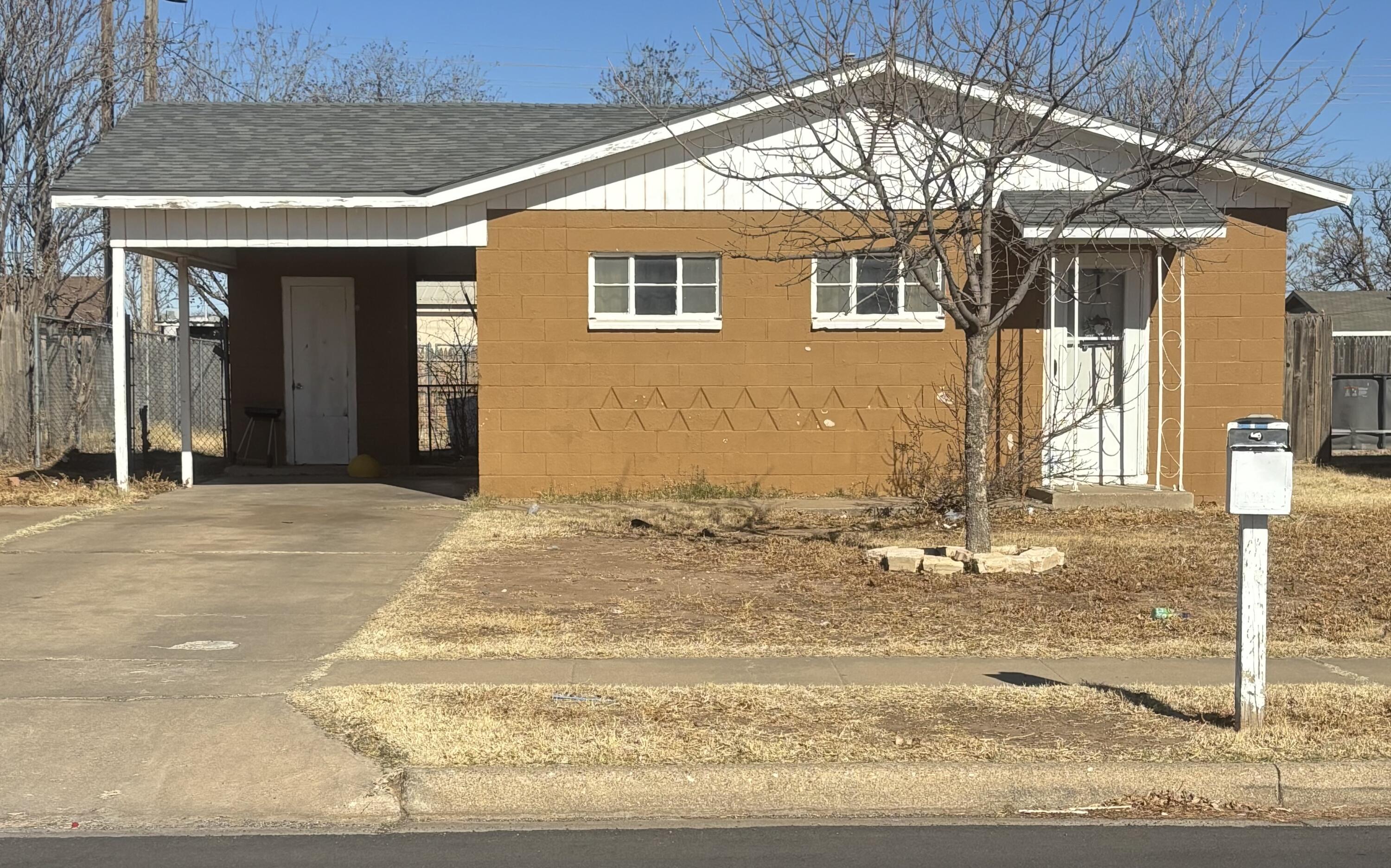 2105 East 29th Street Lubbock, TX 79404 - Photo 1 of 26 a view of a house with a snow on the road
