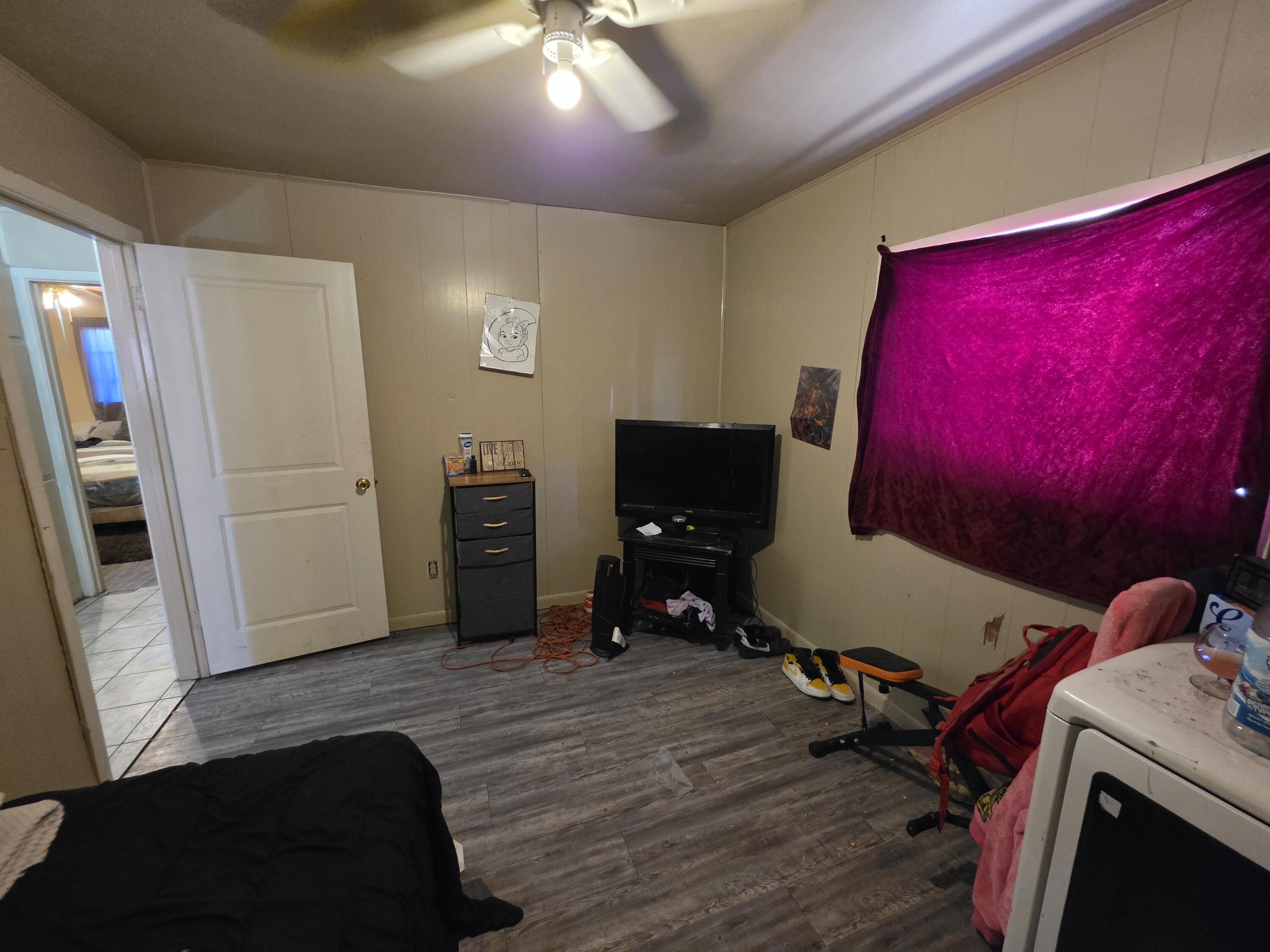 2105 East 29th Street Lubbock, TX 79404 - Photo 13 of 26 a room with furniture and a flat screen tv