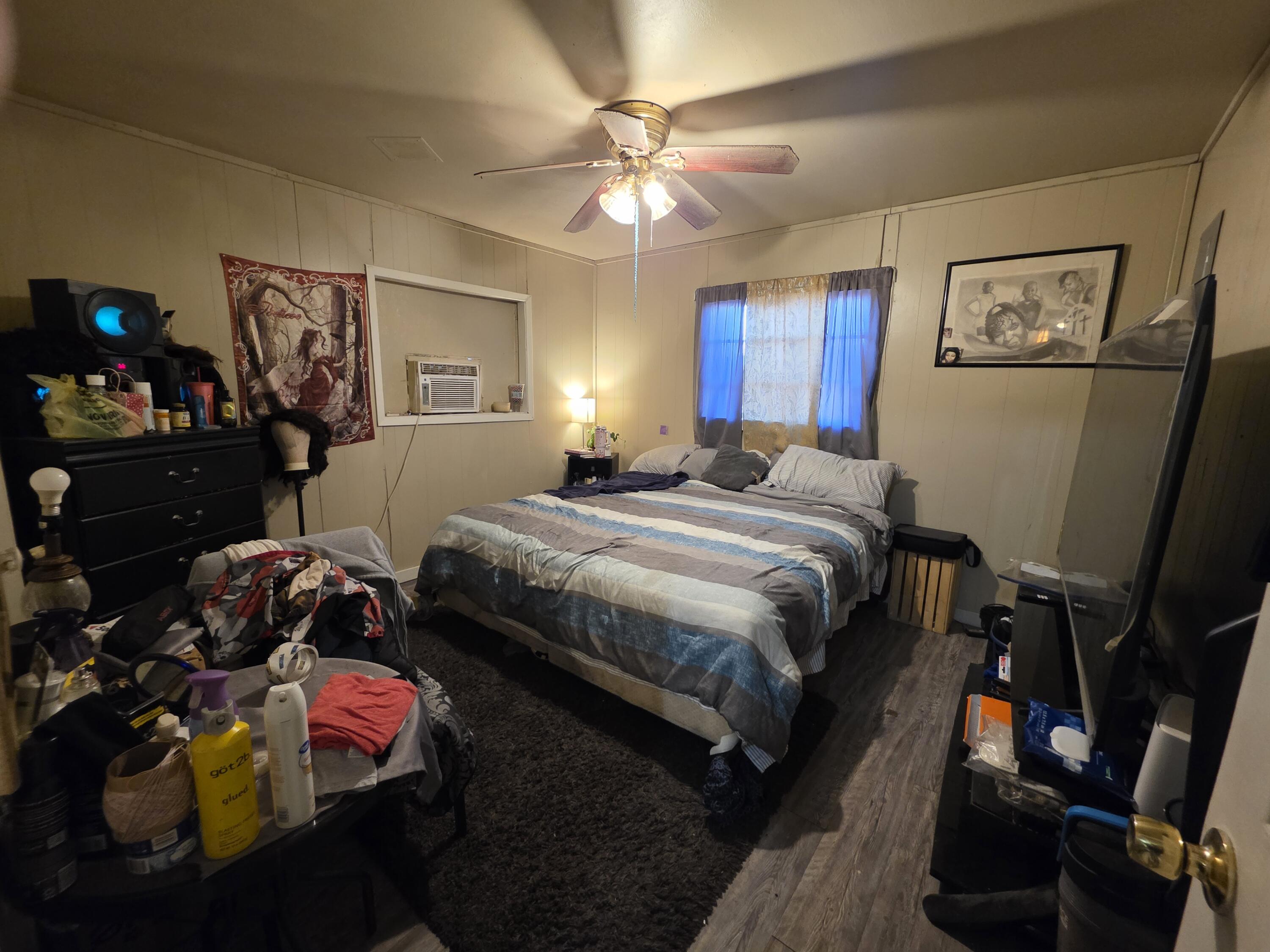 2105 East 29th Street Lubbock, TX 79404 - Photo 16 of 26 a bedroom with bed and a chandelier