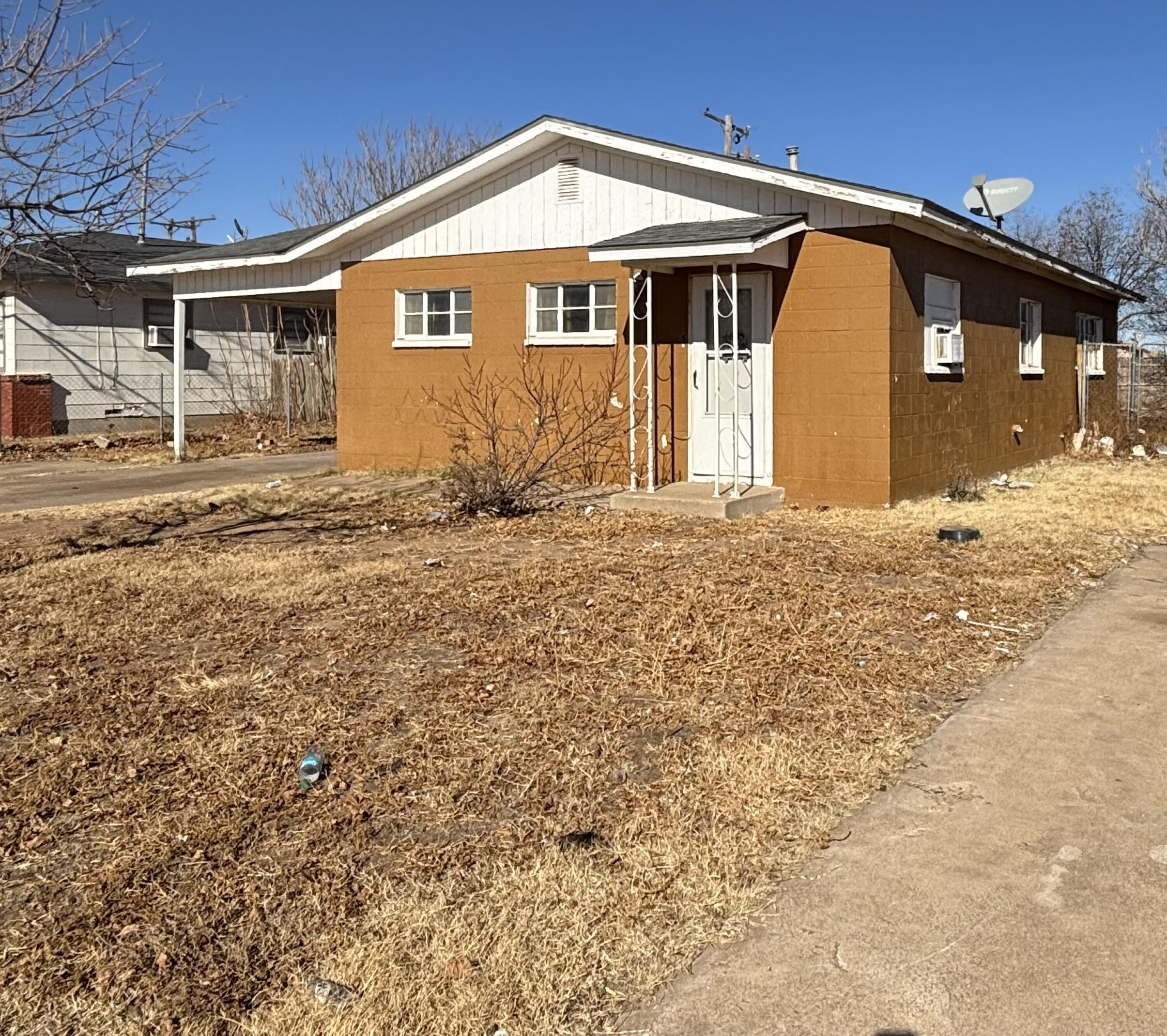 2105 East 29th Street Lubbock, TX 79404 - Photo 2 of 26 a front view of a house with a yard