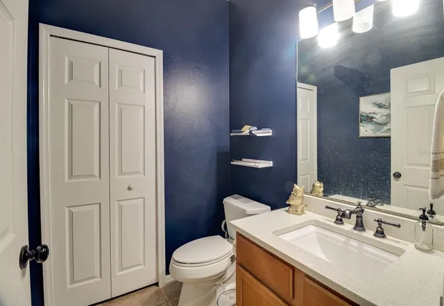 a bathroom with a sink toilet and vanity