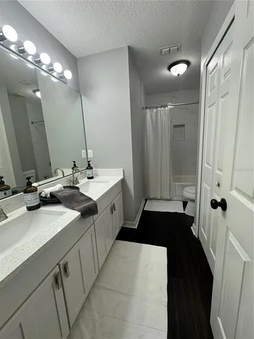 a bathroom with a double vanity sink and mirror