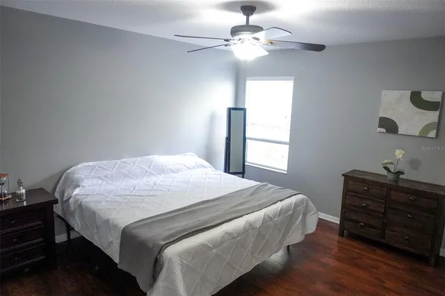 a bedroom with a bed chandelier and a window