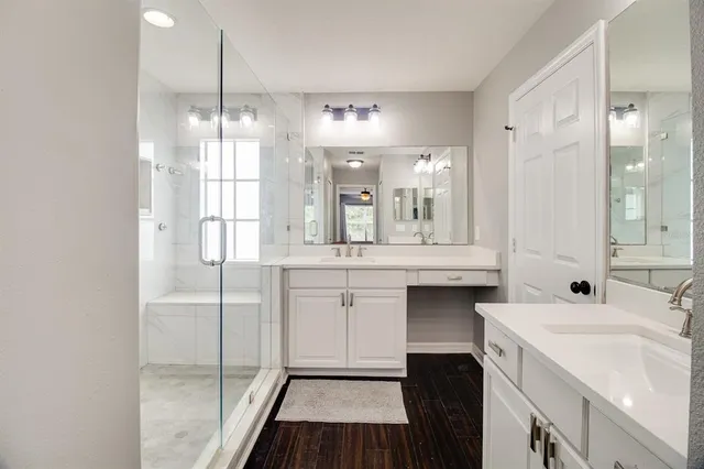 a bathroom with a double vanity sink mirror and