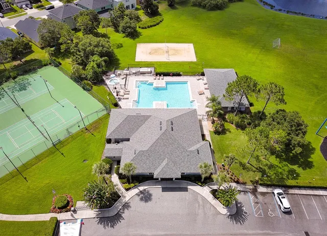 an aerial view of a house with a yard swimming pool and outdoor seating