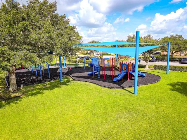 a view of a swimming pool with a patio and a yard