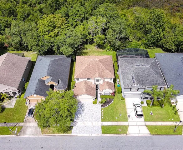 an aerial view of a house with a yard basket ball court and outdoor seating
