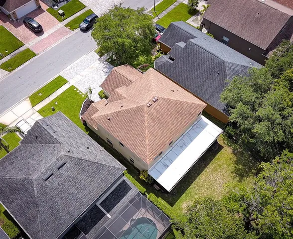 an aerial view of a house with a backyard