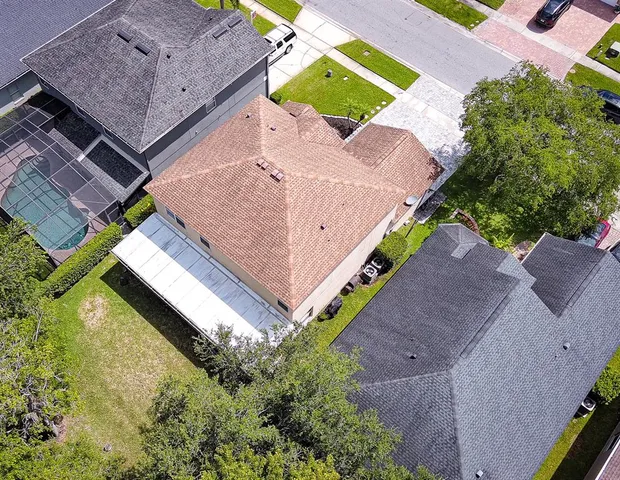 an aerial view of a house with a yard