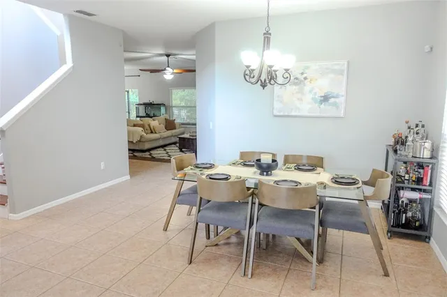 a view of a dining room with furniture and chandelier