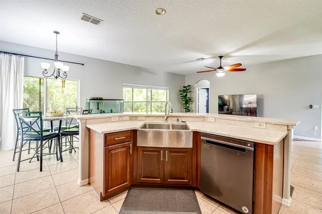 a kitchen with center island table and chairs