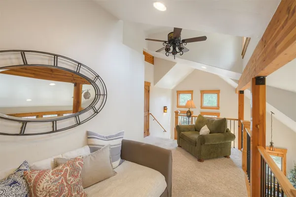 a living room with furniture and a mirror