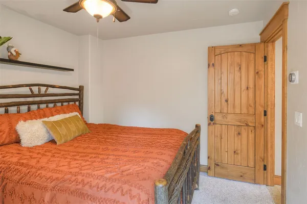 a bedroom with a bed and a chandelier
