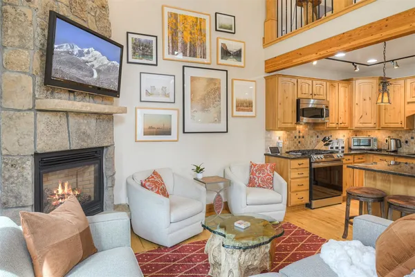 a living room with fireplace furniture and a flat screen tv
