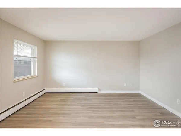 a kitchen with a refrigerator a stove a sink and white cabinets