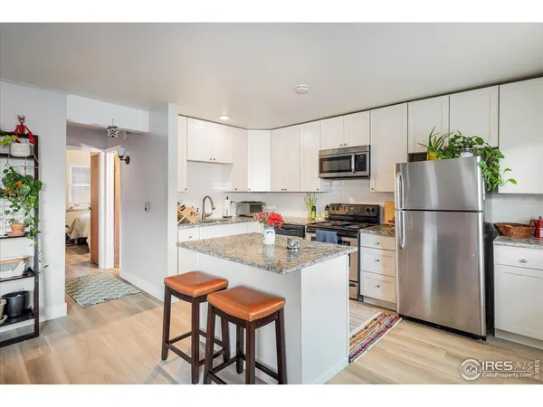 a kitchen with sink and cabinets