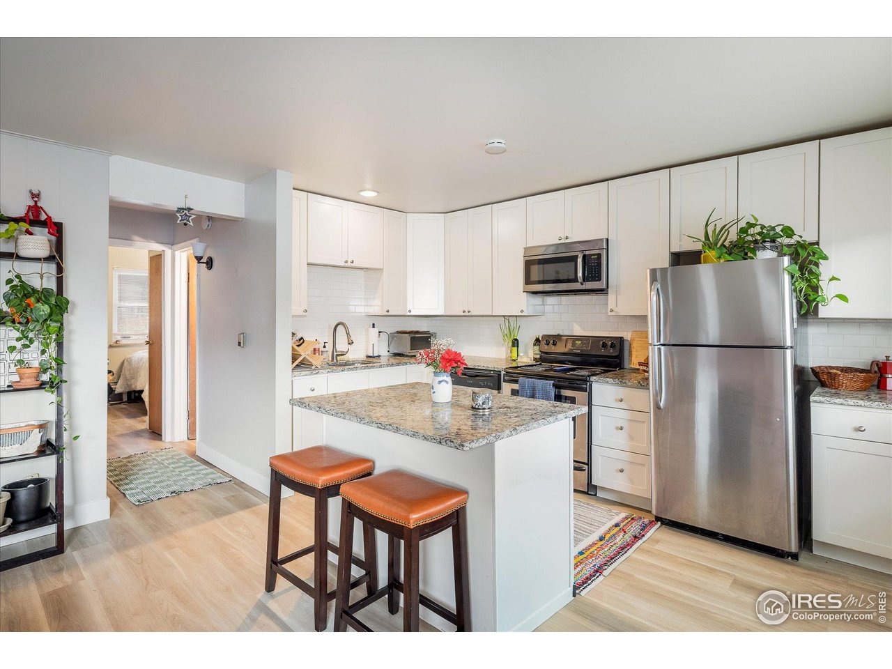 1938 Spruce Street Boulder, CO 80302 - Photo 34 of 50 a kitchen with stainless steel appliances granite countertop a refrigerator a stove a sink a dining table and chairs