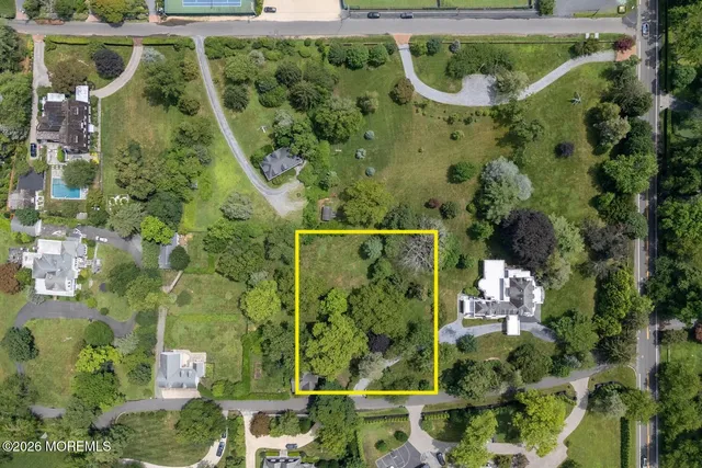 an aerial view of a residential houses with yard