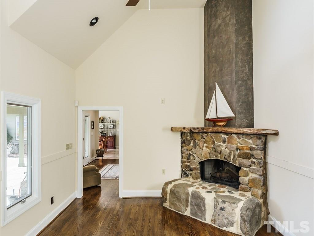 2125 Olive Chapel Road Apex, NC 27502 - Photo 12 of 25 The den would make a great man cave, play room, study...whatever your heart desires. The stone boulder used for the fireplace came from the property.