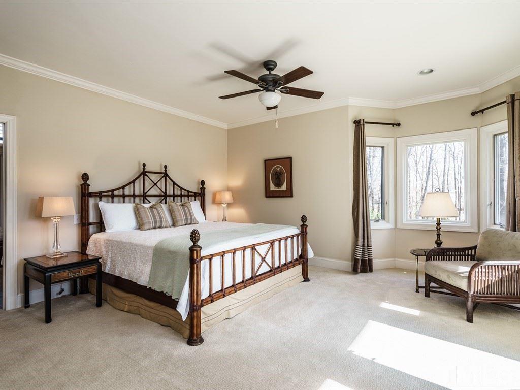 2125 Olive Chapel Road Apex, NC 27502 - Photo 13 of 25 Huge master bedroom includes a very large walk in closet. Windows on the right overlook field and pond, and a door opens directly to the expansive covered veranda..