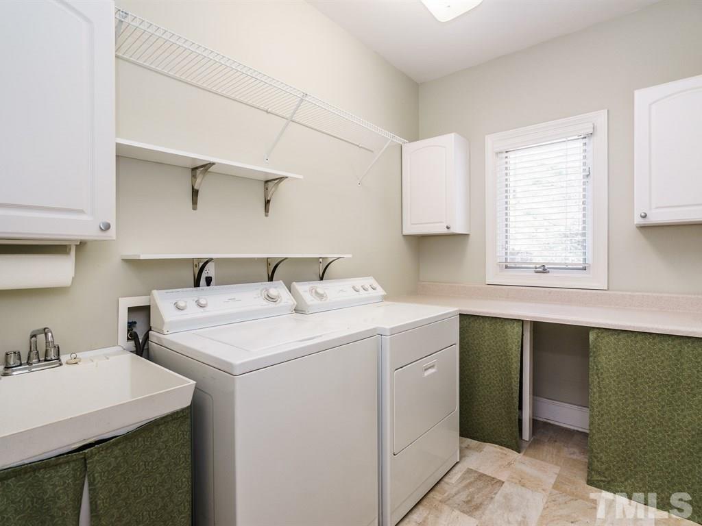 2125 Olive Chapel Road Apex, NC 27502 - Photo 17 of 25 Spacious laundry room with ample counter space to fold laundry or do projects, and cabinet storage.