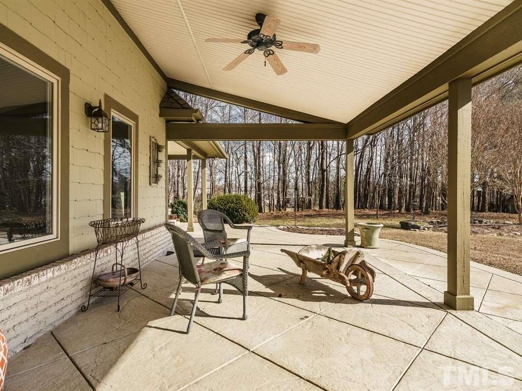 2125 Olive Chapel Road Apex, NC 27502 - Photo 22 of 25 Covered veranda can be accessed from several areas of the home. It has wonderful views of the property and a large pond beyond.