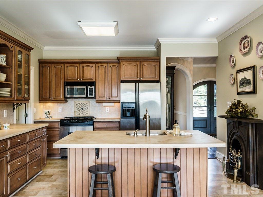 Kitchen with island and gas range.  The fireplace on the right is decorative.